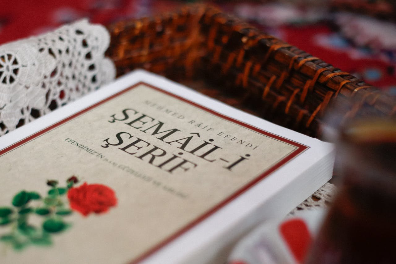 Close-up of the Semail-i Serif book with a woven basket and lace in the background.
